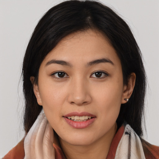 Joyful latino young-adult female with long  brown hair and brown eyes
