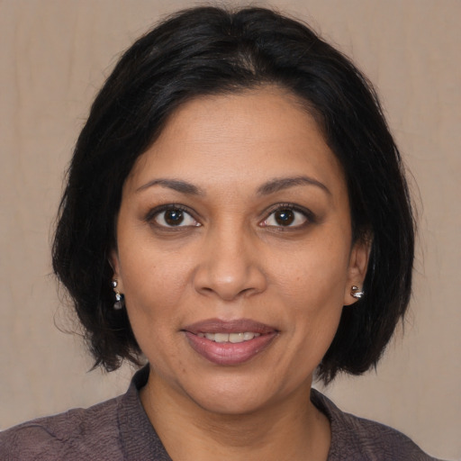 Joyful black adult female with medium  brown hair and brown eyes