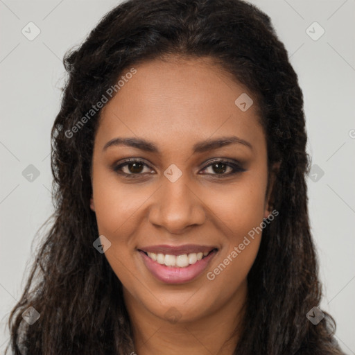 Joyful black young-adult female with long  brown hair and brown eyes