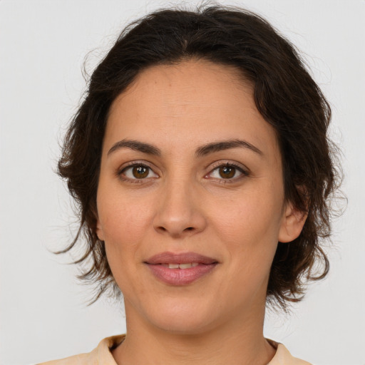 Joyful white adult female with medium  brown hair and brown eyes