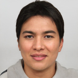 Joyful asian young-adult male with short  black hair and brown eyes