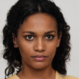 Neutral black young-adult female with medium  brown hair and brown eyes