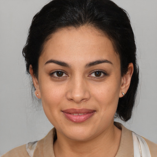 Joyful latino young-adult female with medium  brown hair and brown eyes