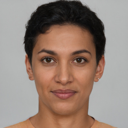 Joyful latino young-adult female with short  brown hair and brown eyes
