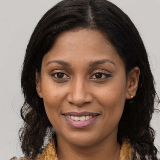 Joyful black young-adult female with medium  brown hair and brown eyes