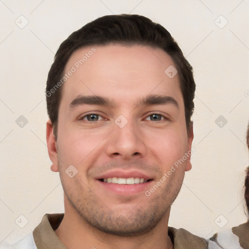 Joyful white young-adult male with short  brown hair and brown eyes