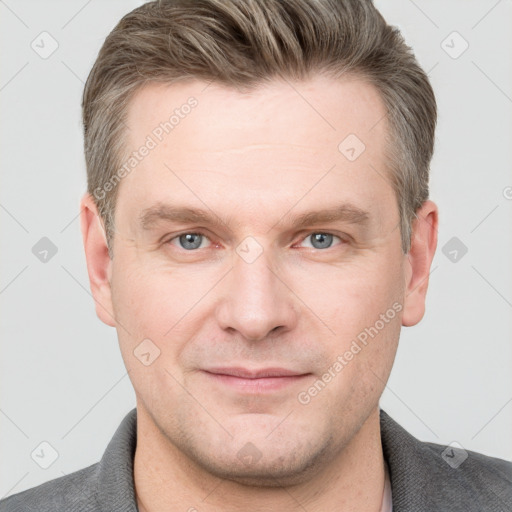 Joyful white adult male with short  brown hair and grey eyes