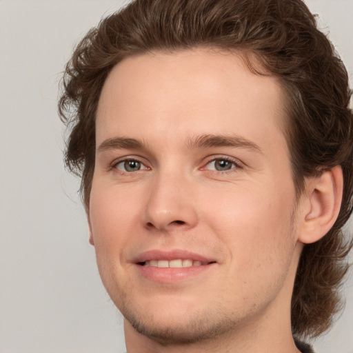 Joyful white young-adult male with medium  brown hair and brown eyes