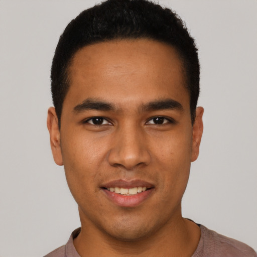 Joyful latino young-adult male with short  black hair and brown eyes