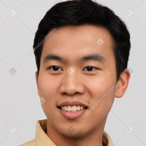 Joyful asian young-adult male with short  black hair and brown eyes