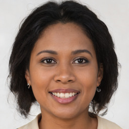 Joyful latino young-adult female with long  brown hair and brown eyes