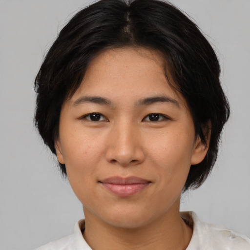 Joyful asian young-adult female with medium  black hair and brown eyes