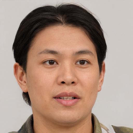Joyful asian adult male with short  brown hair and brown eyes