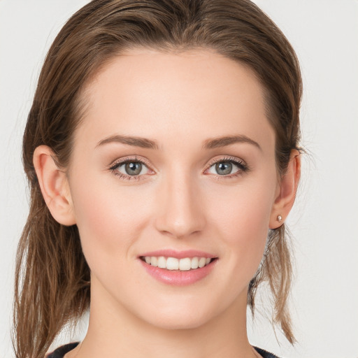 Joyful white young-adult female with long  brown hair and grey eyes