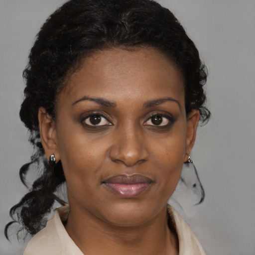 Joyful black young-adult female with medium  brown hair and brown eyes