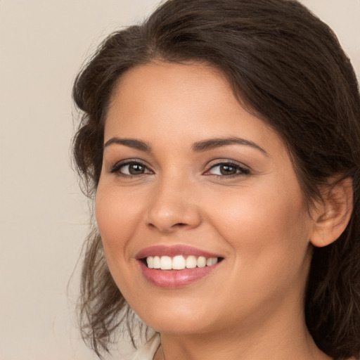 Joyful white young-adult female with medium  brown hair and brown eyes