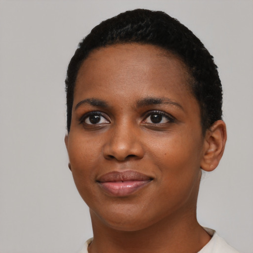 Joyful black young-adult female with short  black hair and brown eyes