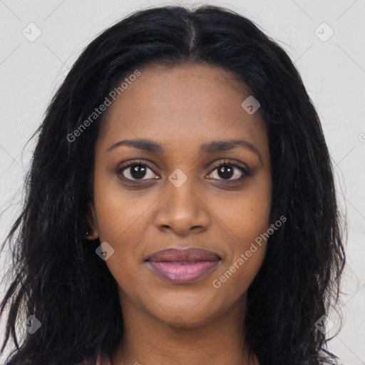 Joyful black young-adult female with long  black hair and brown eyes