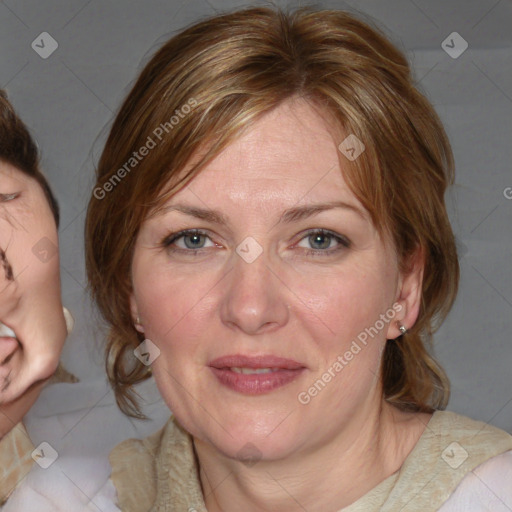 Joyful white adult female with medium  brown hair and blue eyes