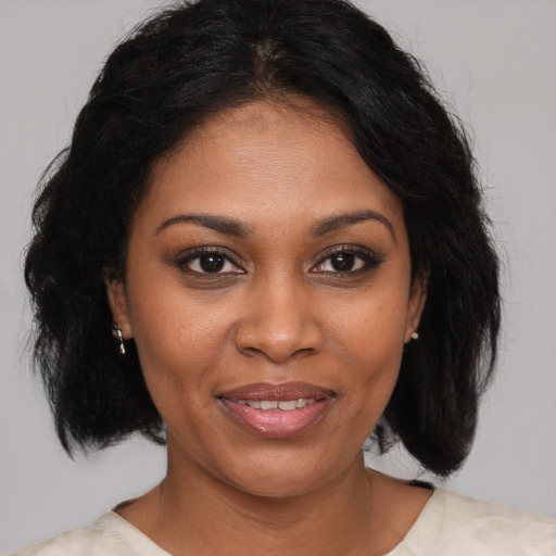 Joyful black young-adult female with medium  brown hair and brown eyes