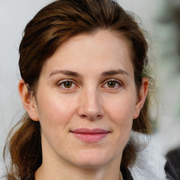 Joyful white adult female with medium  brown hair and grey eyes