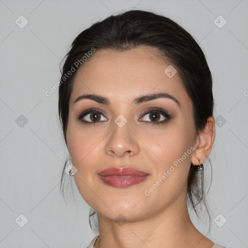 Joyful latino young-adult female with medium  brown hair and brown eyes