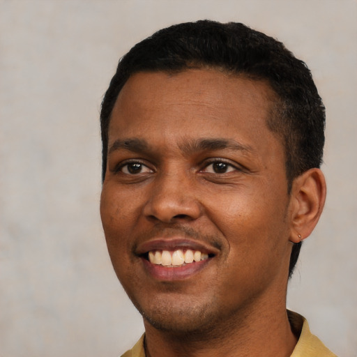 Joyful black young-adult male with short  black hair and brown eyes
