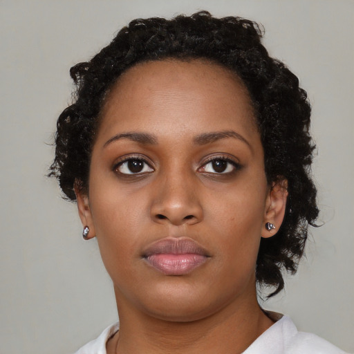 Neutral black young-adult female with medium  brown hair and brown eyes
