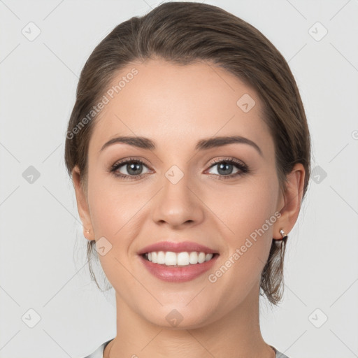 Joyful white young-adult female with medium  brown hair and grey eyes