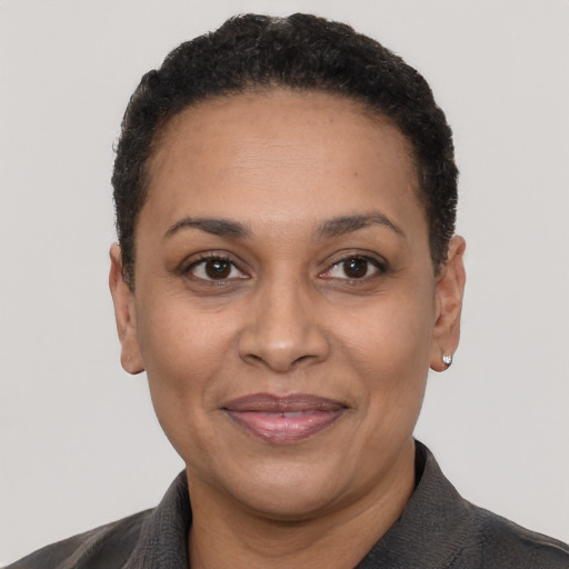 Joyful latino adult female with short  black hair and brown eyes