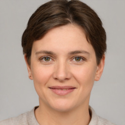 Joyful white young-adult female with short  brown hair and grey eyes