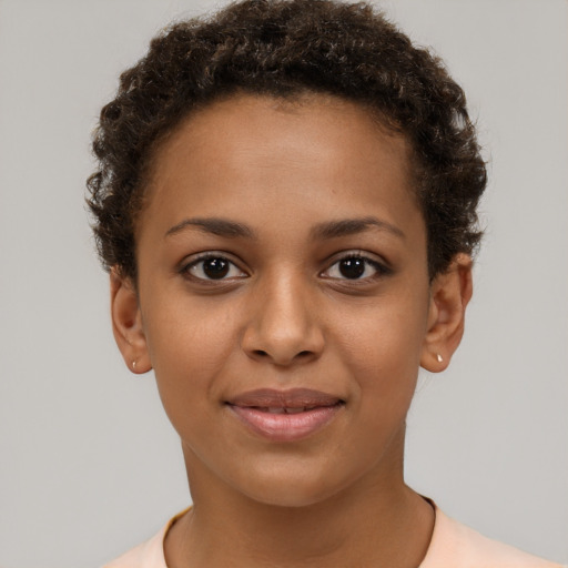 Joyful black young-adult female with short  brown hair and brown eyes