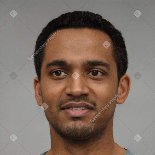 Joyful black young-adult male with short  black hair and brown eyes