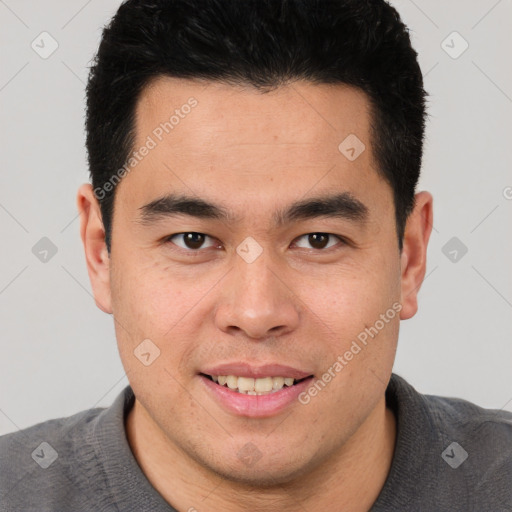 Joyful asian young-adult male with short  black hair and brown eyes