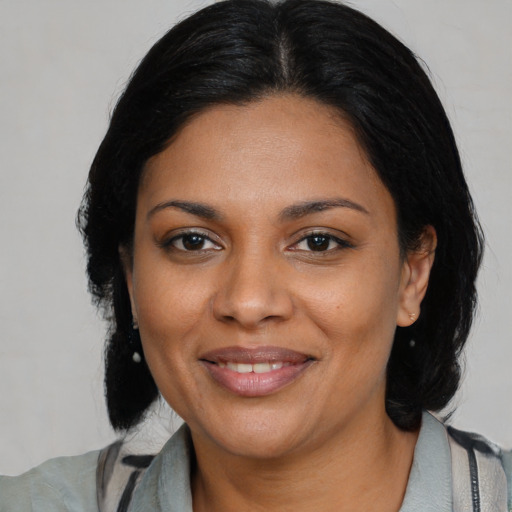 Joyful black young-adult female with medium  brown hair and brown eyes