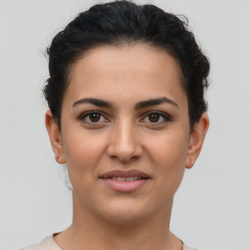 Joyful latino young-adult female with short  brown hair and brown eyes