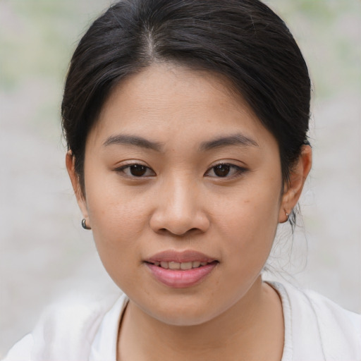 Joyful asian young-adult female with medium  brown hair and brown eyes