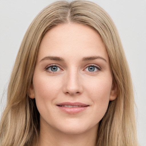 Joyful white young-adult female with long  brown hair and green eyes