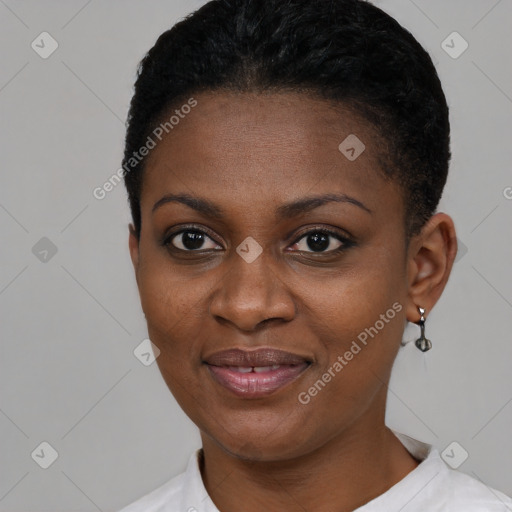 Joyful black young-adult female with short  black hair and brown eyes