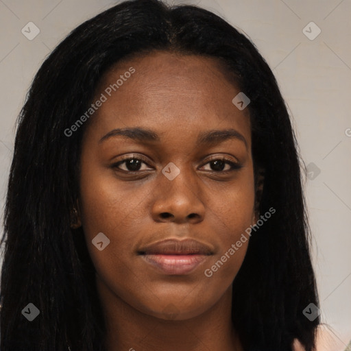 Joyful black young-adult female with long  black hair and brown eyes