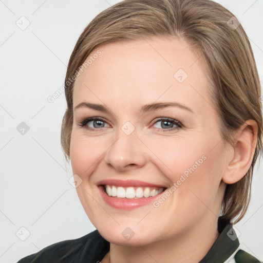 Joyful white young-adult female with medium  brown hair and grey eyes