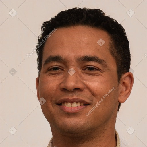 Joyful white young-adult male with short  black hair and brown eyes