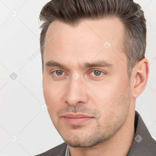 Joyful white adult male with short  brown hair and brown eyes