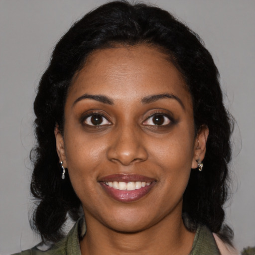 Joyful black young-adult female with medium  black hair and brown eyes