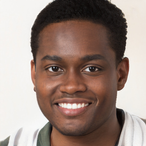 Joyful black young-adult male with short  brown hair and brown eyes