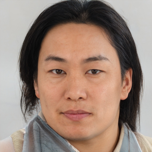 Joyful asian young-adult male with medium  brown hair and brown eyes