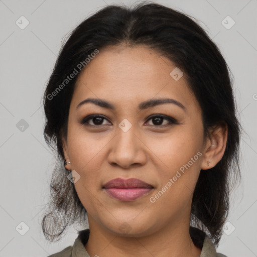 Joyful latino adult female with medium  brown hair and brown eyes