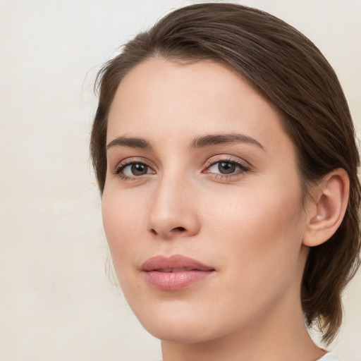 Joyful white young-adult female with medium  brown hair and green eyes