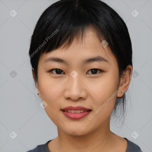 Joyful asian young-adult female with medium  black hair and brown eyes