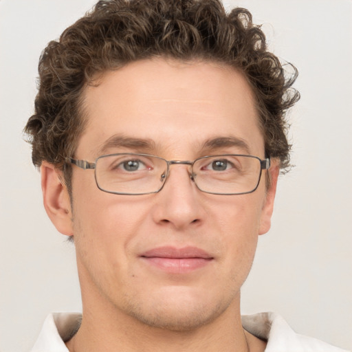 Joyful white adult male with short  brown hair and grey eyes